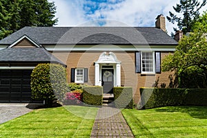 Modern brick house with classic entranceway and pretty landscaping