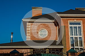 Modern brick house with round and rectangular windows