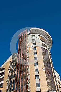 Modern brick multistory house on deep blue sky bac