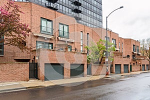 Modern brick row houses along a street in a residential district on a rainy day