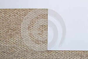 Modern brick wall with white painted plaster background