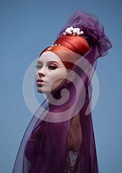 Modern bridal look. Portrait of young, beautiful redhead bride over studio background. Woman with makeup and haircut.