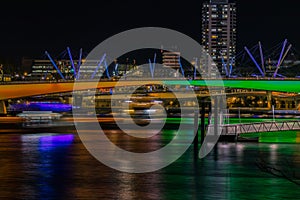 Modern bridge over river in night city