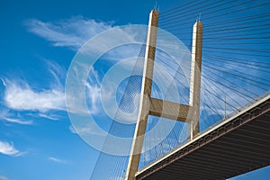 Modern bridge pylon against blue sky. Multi-span cable-stayed bridge. Cable-stayed suspension Alex Fraser Bridge