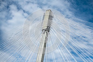 Modern bridge pylon against blue sky. Multi-span cable-stayed bridge. White cable-stayed suspension Alex Fraiser Bridge