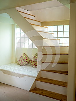 The modern bright apartment with wooden staircase