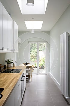 Modern bright kitchen, galley style photo