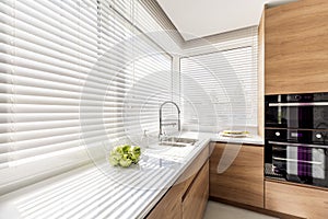 Kitchen with white window blinds