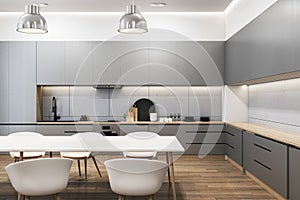 Modern bright wooden and concrete kitchen interior with dining area. Luxury designs concept.