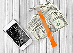Modern broken mobile phone, hammer and dollars on white