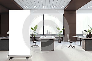 Modern brown coworking office interior with empty white roll-up banner, panoramic windows and city view. 3D Rendering