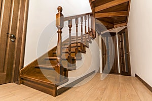 Modern brown oak wooden stairs and doors in new renovated house