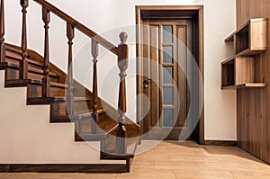 Modern brown oak wooden stairs and doors in new renovated house