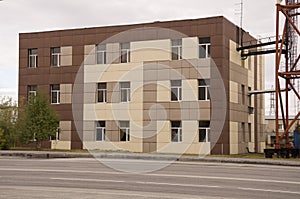 Modern brown three-storeyed building in the city