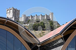 Modern building against old spanish castle