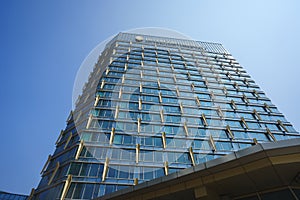 Modern building architecture, the InterContinental Hotel exterior against blue sky in Quanzhou, China