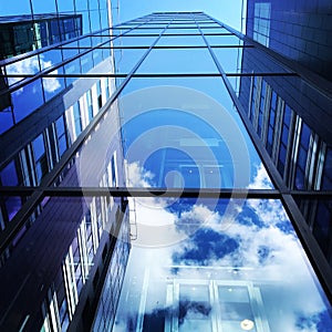 Modern building with blue sky and cloud reflections