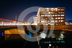 Modern building and bridge over Codorus Creek at night, in York, Pennsylvania.