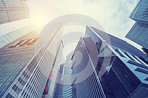 Modern building at business center city. Look up view with sunlight. Architecture, construction, investment, finance. Abstract ba