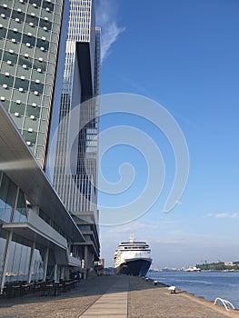 Modern building and a cruiseboat against a clear blue sky