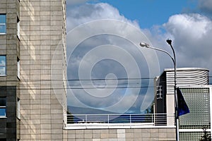 modern building and dynamic blue sky with white clouds. blurry green mountain