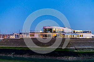 Modern Building at the embankment in the harbor of Blankenberge, Belgium, Belgian architecture by night