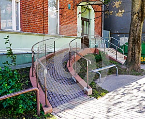 Modern building entrance with ramp for wheelchair