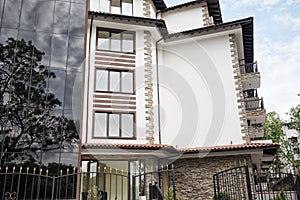 Modern Building Exterior. Facade of a Modern Apartment Building. Vacation Complex Hotel Building, With Stone Tiling Facade