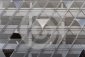 Modern building facade features a triangles pattern or construction contemporary exterior made of grey iron triangle repetition