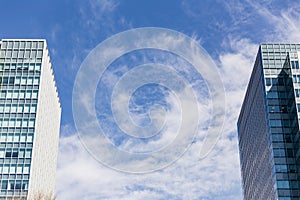 Modern building facede with rectangle and square windows form place in side of grame with clear blue sky with cloud in Sapporo.