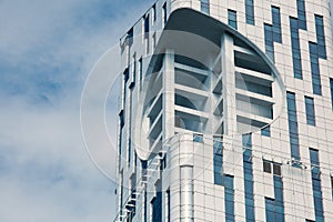 Modern building with glass architecture. Detail of a modern high-rise building. A multi-storey house, windows, metal panels