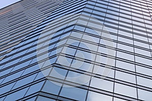 Modern building glass walls with sky and cloud reflection. Blue business background
