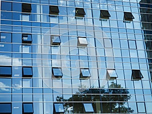 Modern building glass windows with sky reflection