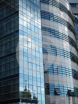 Modern building glass windows with sky reflection