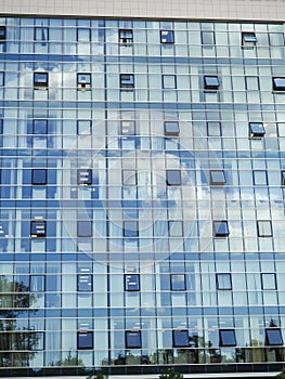 Modern building glass windows with sky reflection