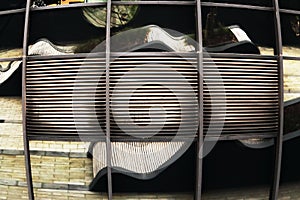 Modern building mirror wall with reflections of park benches