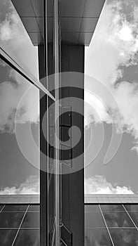 Modern building with open windows and reflecting clouds - Black and white