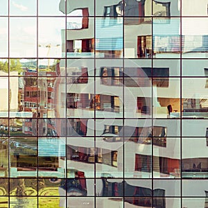 Modern building reflected on glass facade