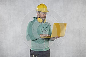 Modern building supervisor keeps the computer in his hands, technology at work