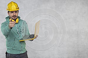 Modern building supervisor keeps the computer in his hands, technology at work