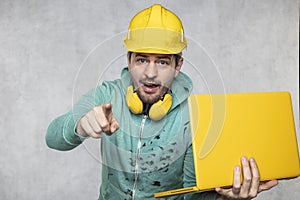 Modern building supervisor keeps the computer in his hands, technology at work