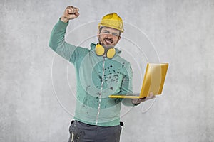 Modern building supervisor keeps the computer in his hands, technology at work