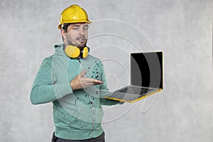 Modern building supervisor keeps the computer in his hands, technology at work