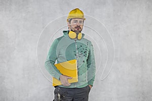 Modern building supervisor keeps the computer in his hands, technology at work