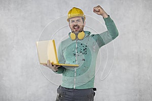 Modern building supervisor keeps the computer in his hands, technology at work