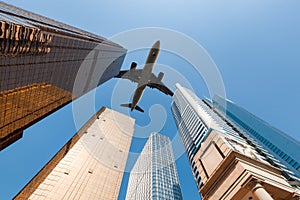 Modern building underneath airplane