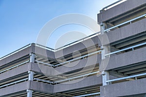 Modern building used as a covered parking garage with blue sky background