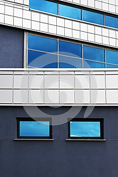 Modern building. Windows with reflection of blue sky