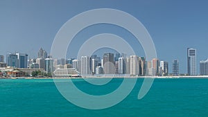 Modern buildings in Abu Dhabi skyline with mall and beach.