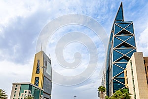 Modern buildings in the Al Olaya downtownt district with palms in the foreground, Al Riyadh, Saudi Arabia photo